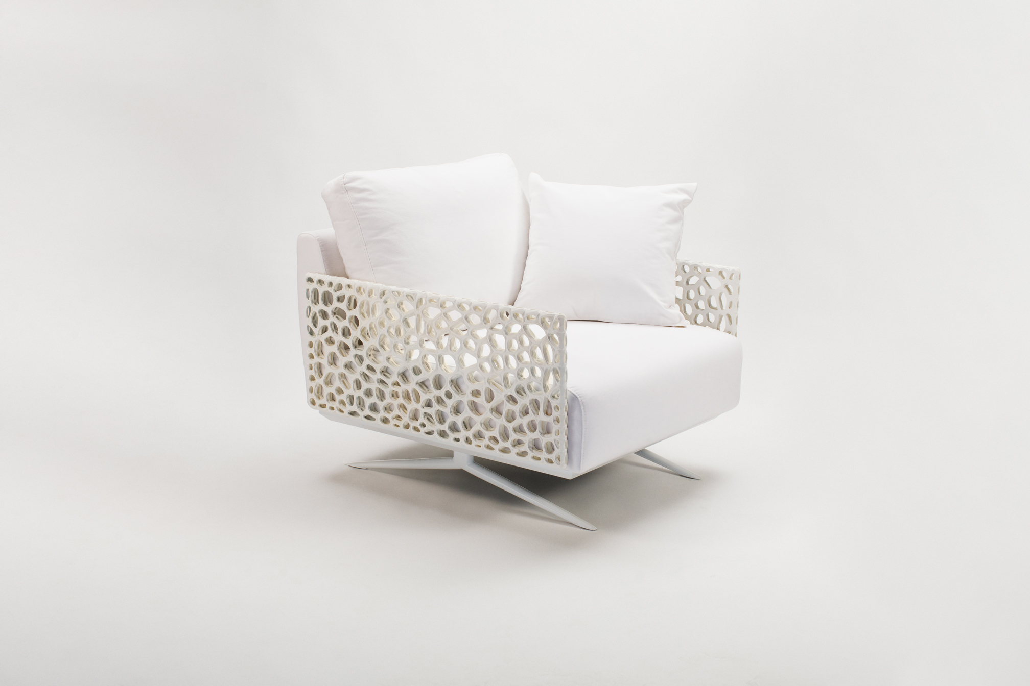 Elegante poltrona bianca con dettagli traforati moderni, ideale per ambienti raffinati e di design.