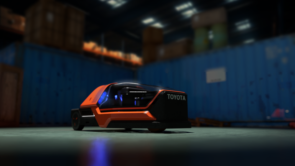 Futuristico veicolo arancione Toyota in un magazzino con container blu sullo sfondo.
