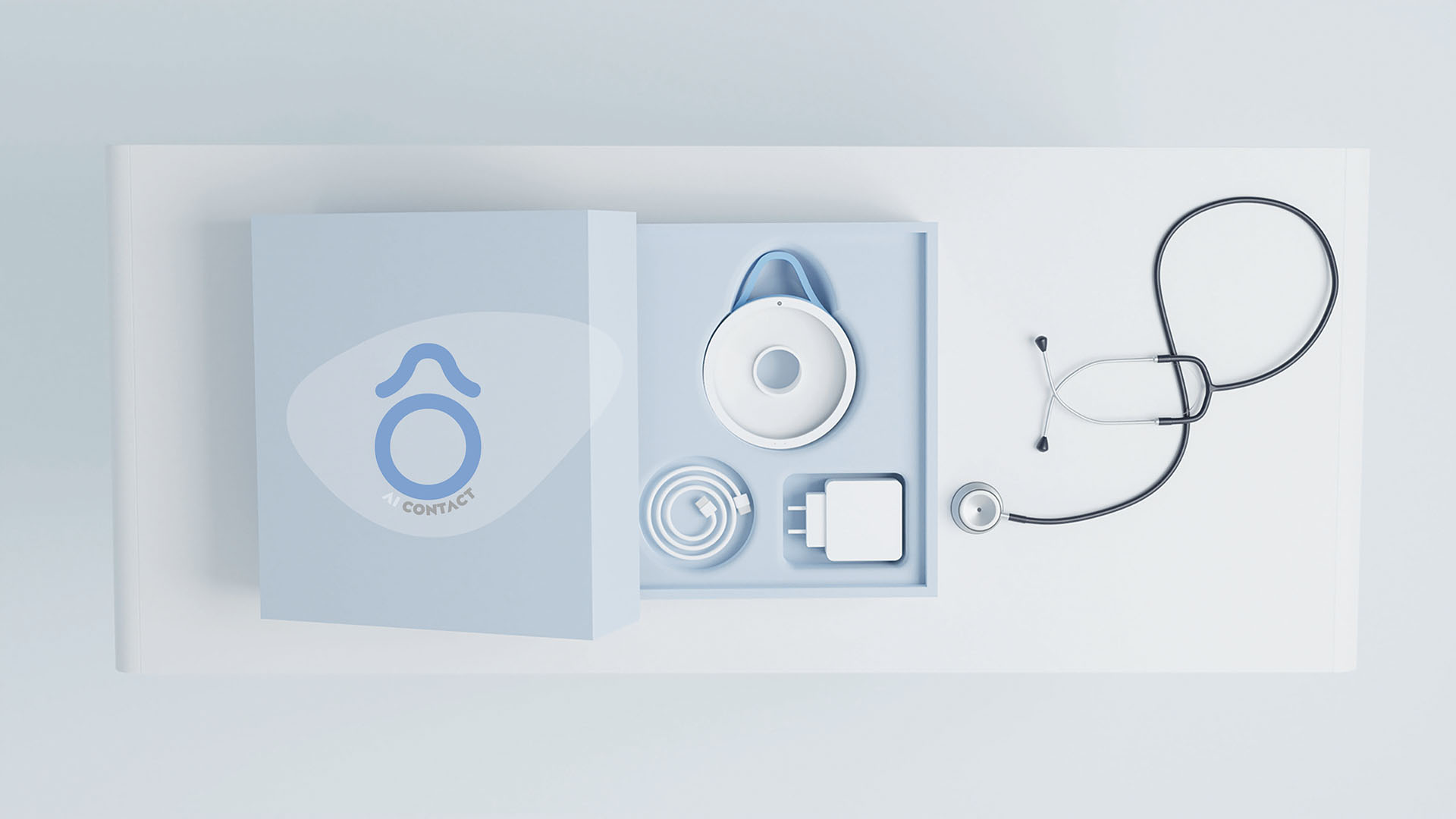 Scatola con dispositivo medico AI, cavo, caricatore e stetoscopio su superficie bianca.